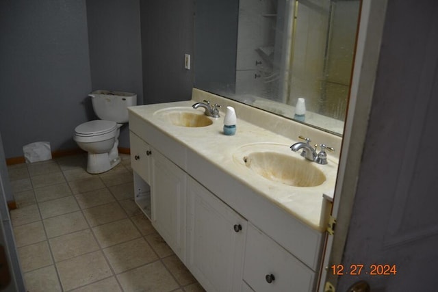 bathroom featuring tile patterned floors, vanity, and toilet