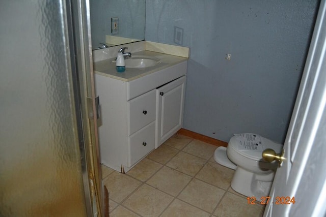 bathroom featuring tile patterned flooring, vanity, and toilet