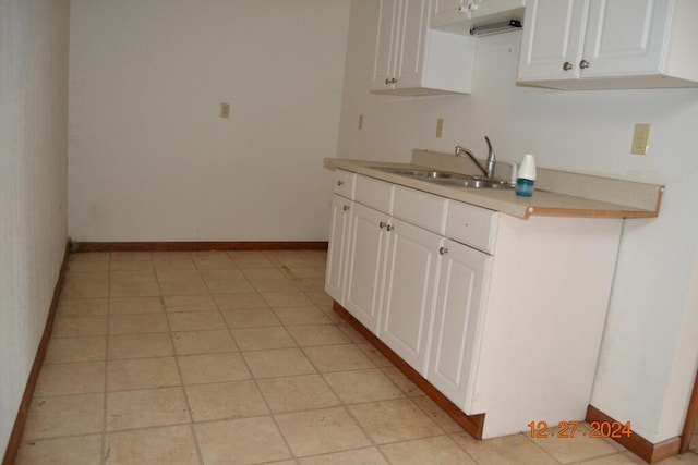 kitchen featuring white cabinets and sink