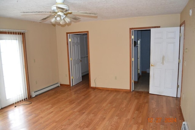 unfurnished bedroom with baseboard heating, ceiling fan, light hardwood / wood-style floors, and a textured ceiling