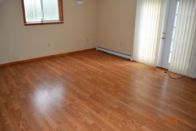 spare room with light hardwood / wood-style flooring and a baseboard radiator