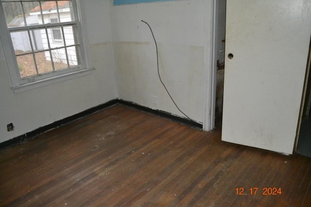 empty room with dark hardwood / wood-style floors