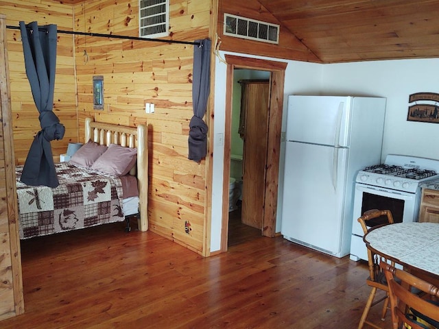 interior space featuring white appliances, wooden walls, vaulted ceiling, dark hardwood / wood-style floors, and wood ceiling