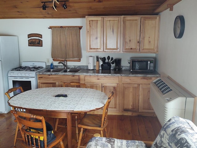 kitchen with light brown cabinets, wood-type flooring, white appliances, and sink