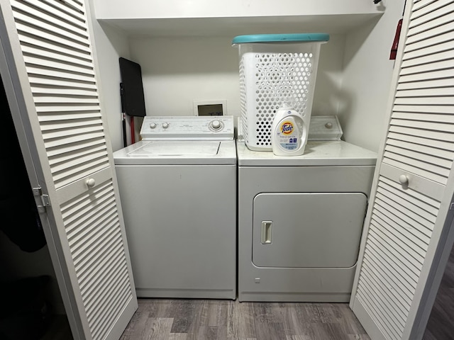 laundry area featuring separate washer and dryer and dark hardwood / wood-style floors