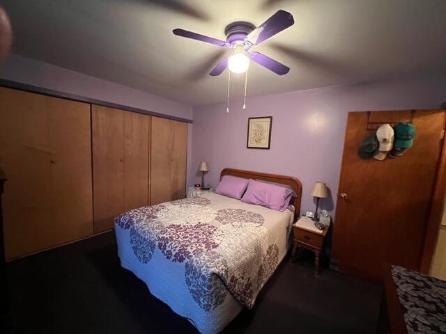 bedroom with ceiling fan and a closet