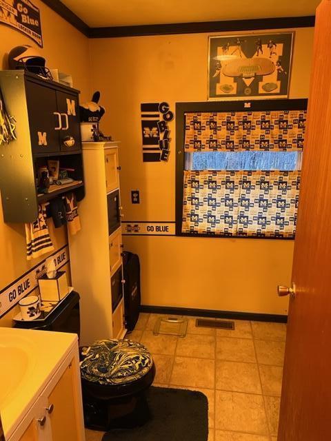 interior space with crown molding and vanity