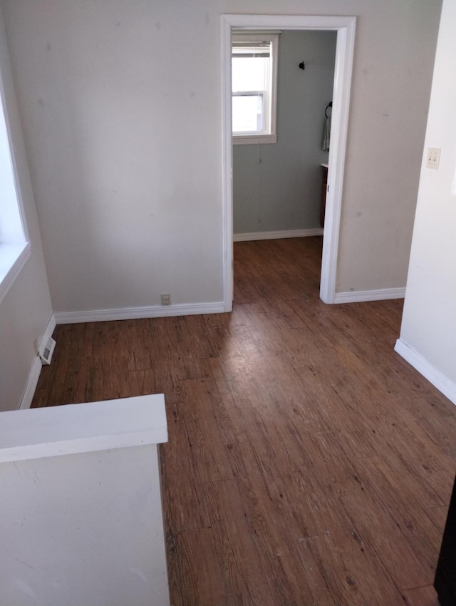 spare room with dark wood-type flooring