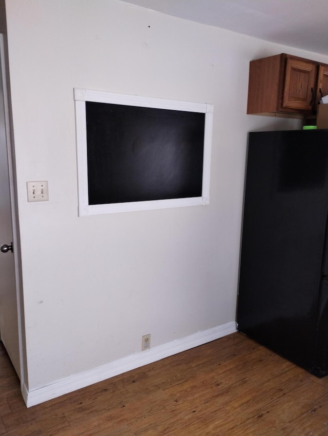 interior space featuring black refrigerator and hardwood / wood-style floors