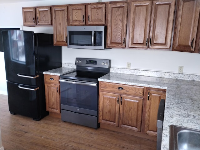 kitchen featuring hardwood / wood-style flooring and stainless steel appliances