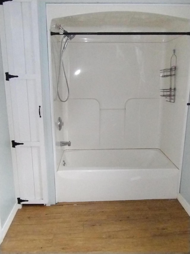 bathroom featuring hardwood / wood-style floors and tub / shower combination