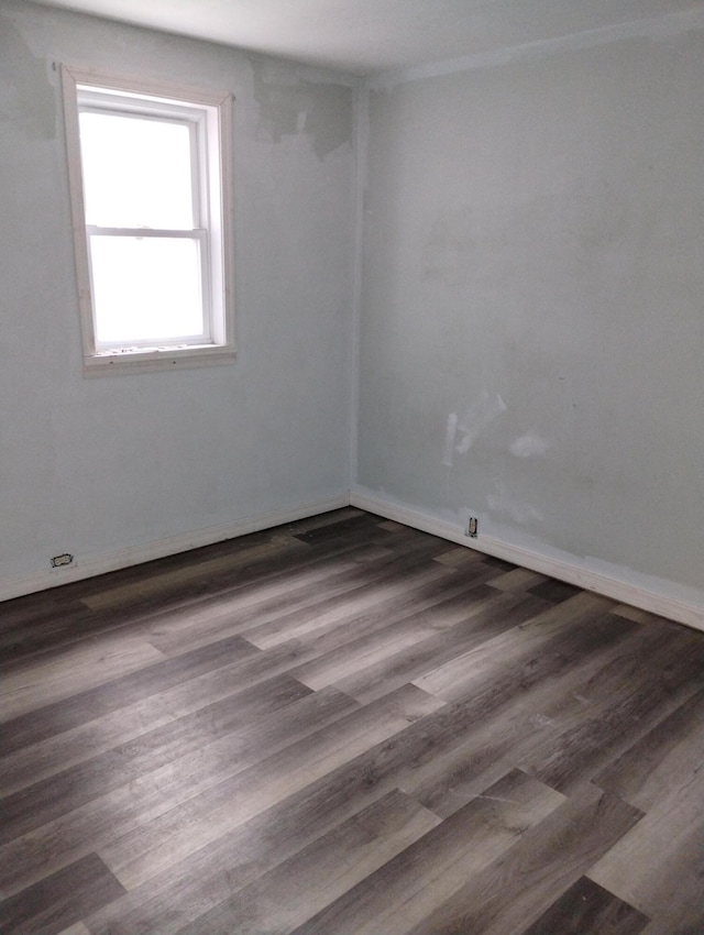 unfurnished room featuring dark hardwood / wood-style flooring