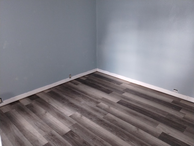 empty room featuring dark wood-type flooring