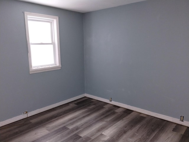 empty room with dark wood-type flooring