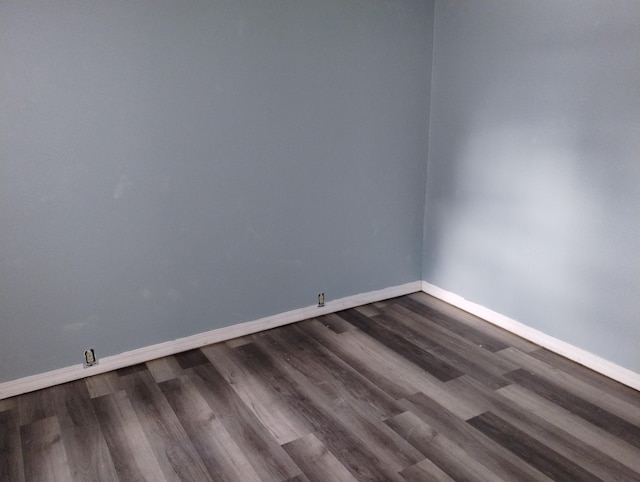 spare room featuring dark hardwood / wood-style floors