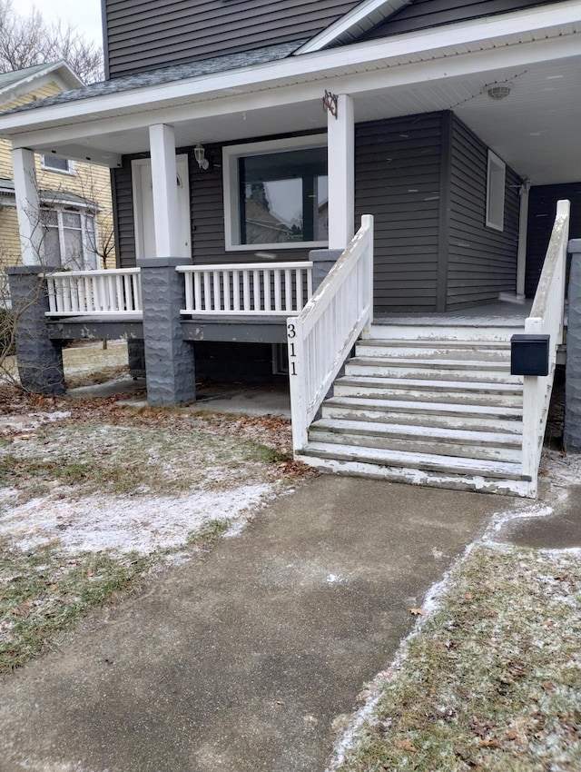 view of exterior entry with covered porch