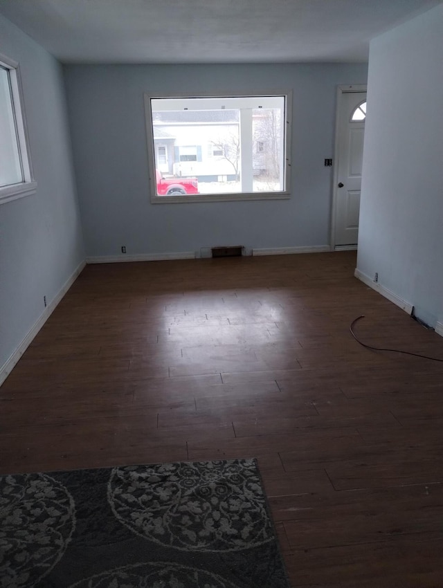 spare room featuring dark wood-type flooring