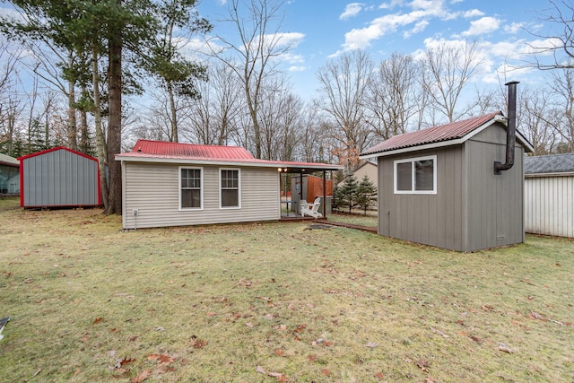 rear view of house with a lawn and a storage shed