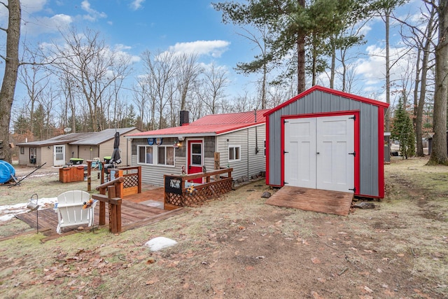 exterior space featuring a shed and a wooden deck