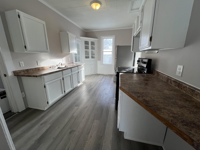 kitchen featuring light hardwood / wood-style floors, white cabinetry, stainless steel electric stove, and sink