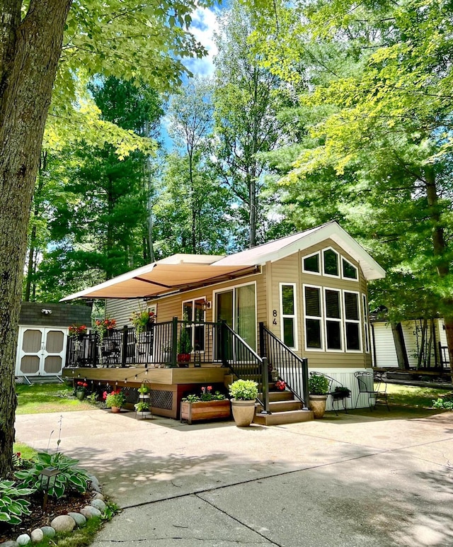 view of front facade with a wooden deck