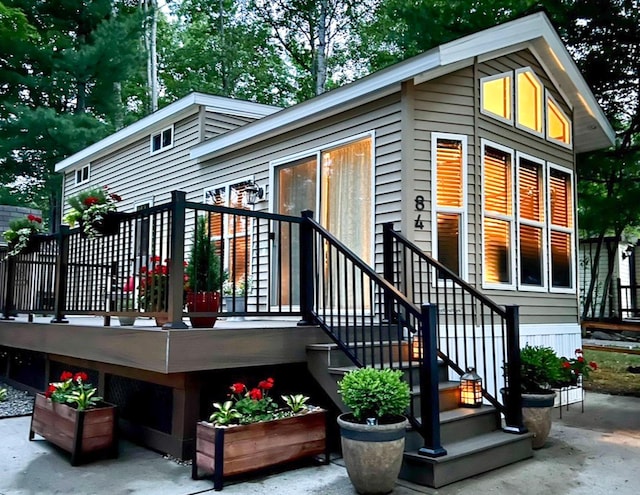 back of property with a wooden deck