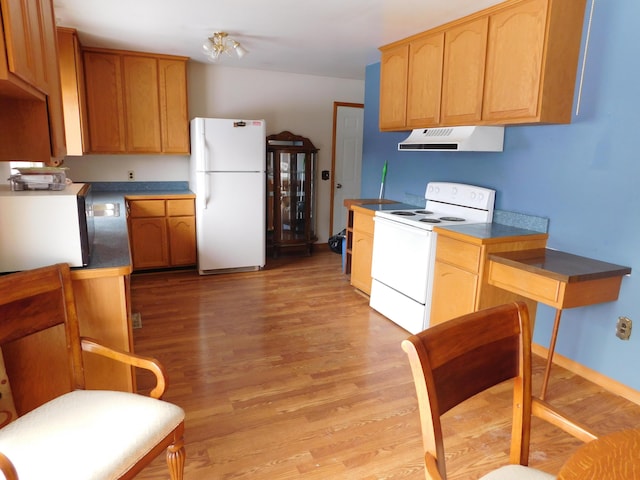 kitchen with light wood-type flooring, white appliances, and range hood