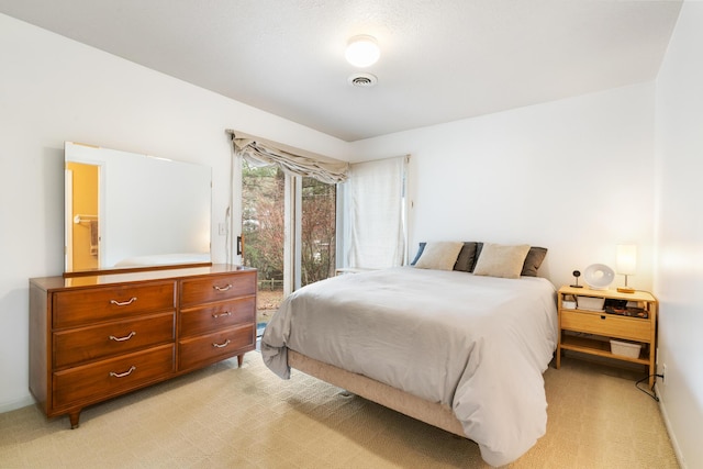 bedroom featuring access to outside and light colored carpet