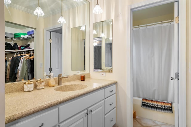 bathroom with ornamental molding, vanity, tile patterned floors, and shower / bath combo with shower curtain