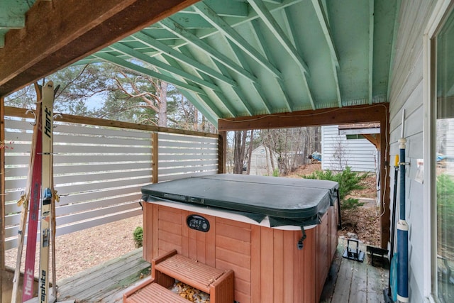 wooden deck with a hot tub