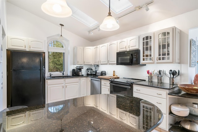 kitchen featuring white cabinetry, sink, backsplash, decorative light fixtures, and black appliances