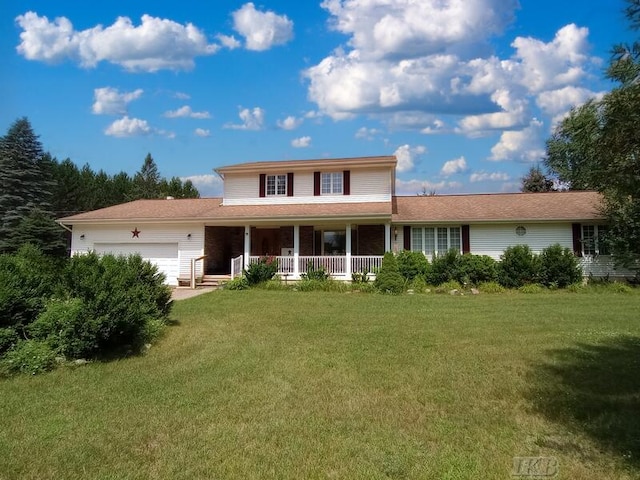 back of house featuring a garage, a lawn, and a porch