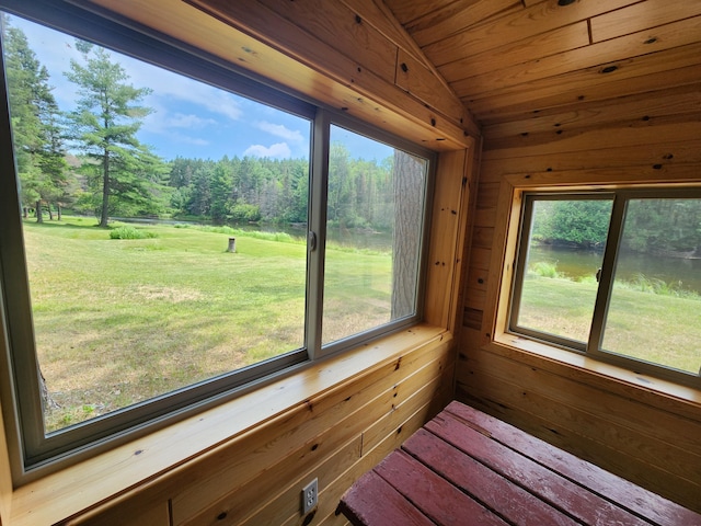 unfurnished sunroom featuring a water view, lofted ceiling, and wood ceiling