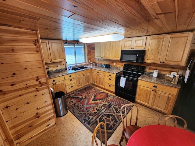 kitchen featuring sink, wooden walls, wooden ceiling, and black appliances