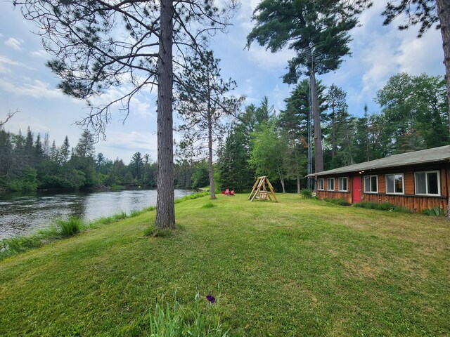 view of yard featuring a water view and a playground