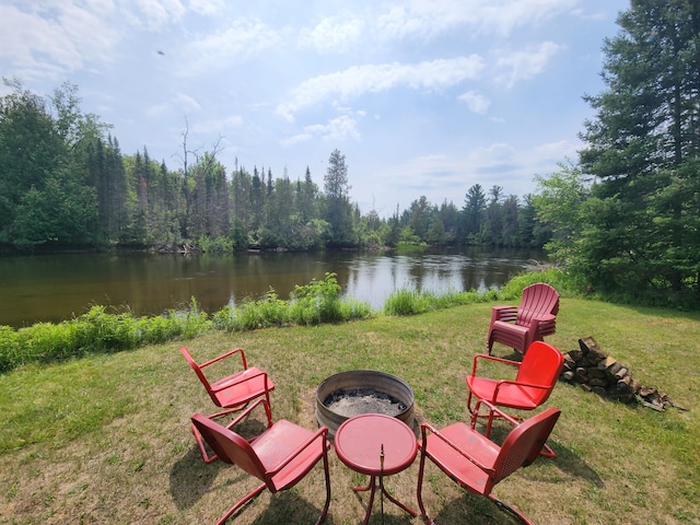 view of yard with a water view and an outdoor fire pit