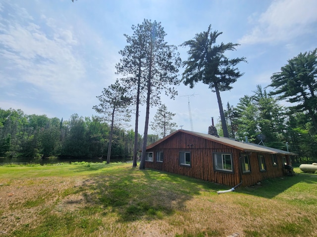 view of property exterior with a lawn