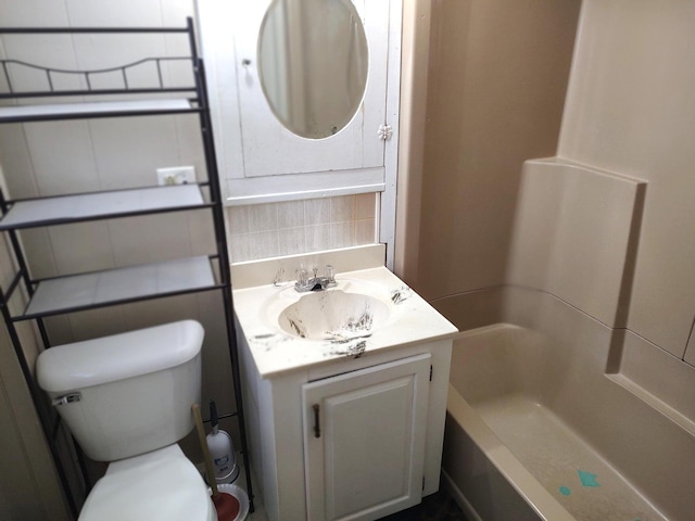 full bathroom featuring shower / bathing tub combination, vanity, and toilet