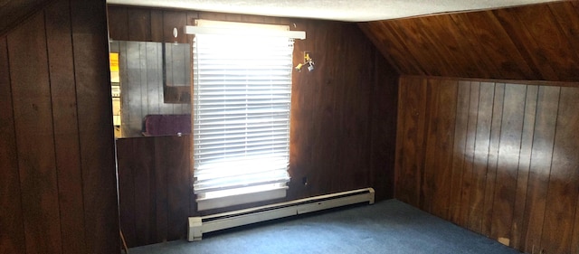 bonus room featuring wood walls, dark carpet, vaulted ceiling, a textured ceiling, and a baseboard radiator