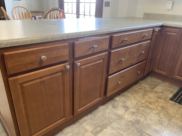 kitchen featuring brown cabinets and light countertops