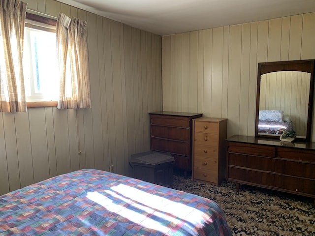 bedroom with wood walls