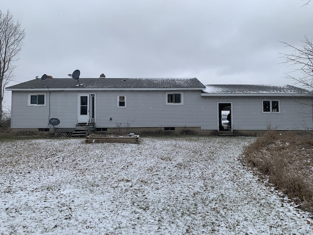 snow covered property with entry steps