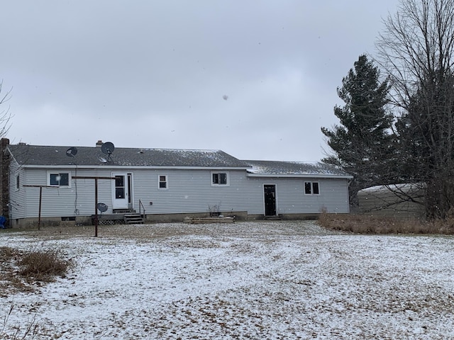 view of snow covered rear of property