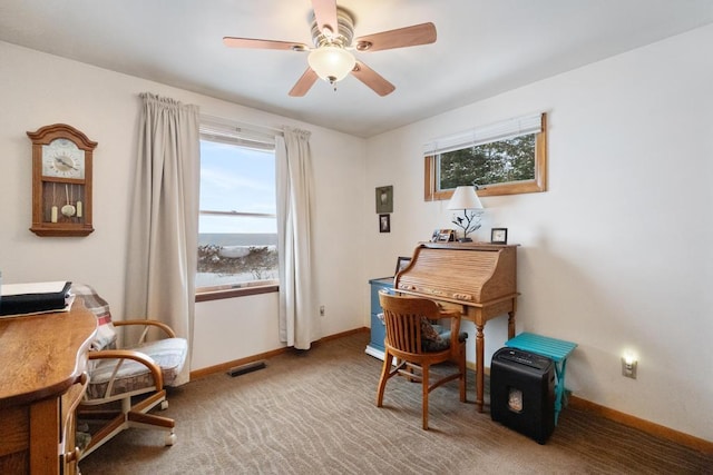 carpeted office space with ceiling fan