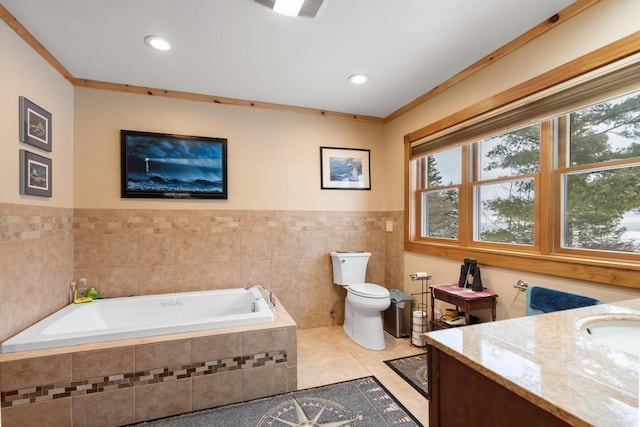 bathroom with tile patterned floors, toilet, ornamental molding, vanity, and a relaxing tiled tub