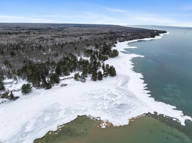 snowy aerial view featuring a water view