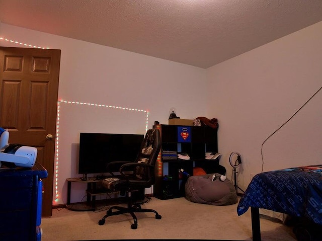 bedroom featuring carpet floors and a textured ceiling