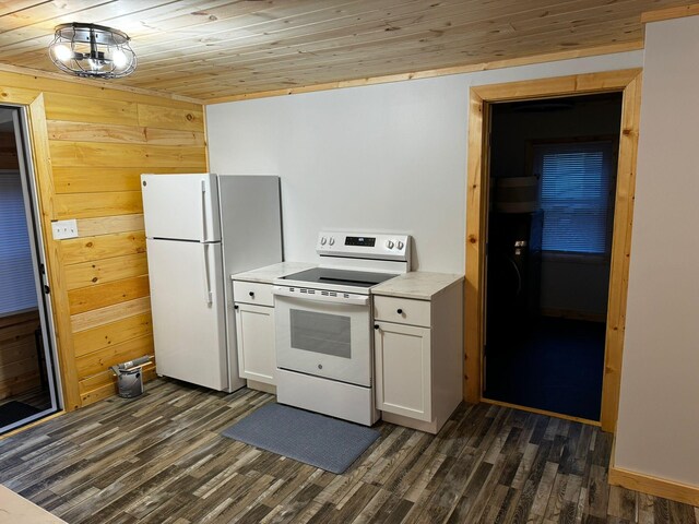 kitchen with wood walls, white appliances, and wood ceiling