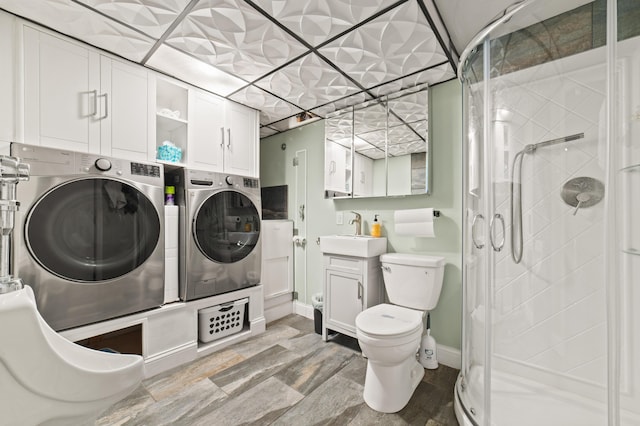 laundry area with washer and clothes dryer and sink