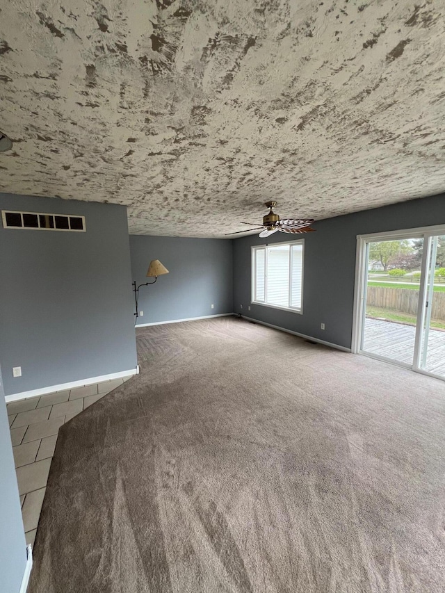 unfurnished room featuring ceiling fan and carpet floors